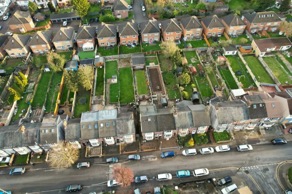 Aerial view of a suburban street of semi-detached houses with long gardens