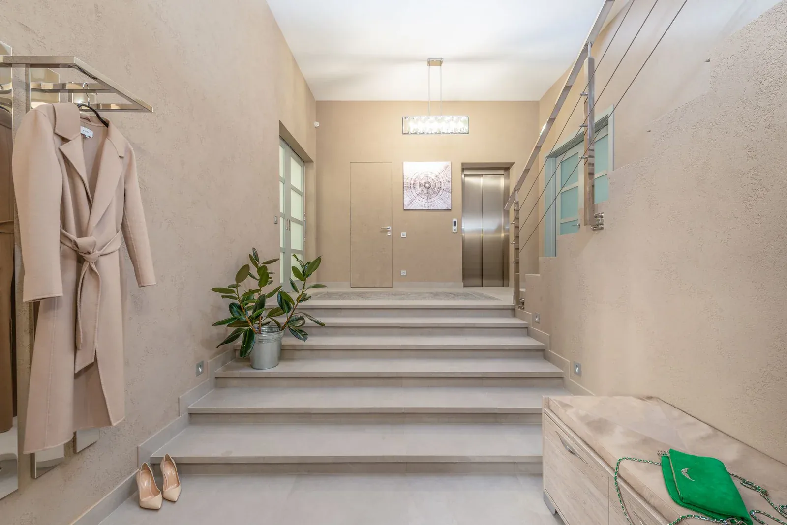 Apartment block entrance lobby with stairs and a lift at the far end