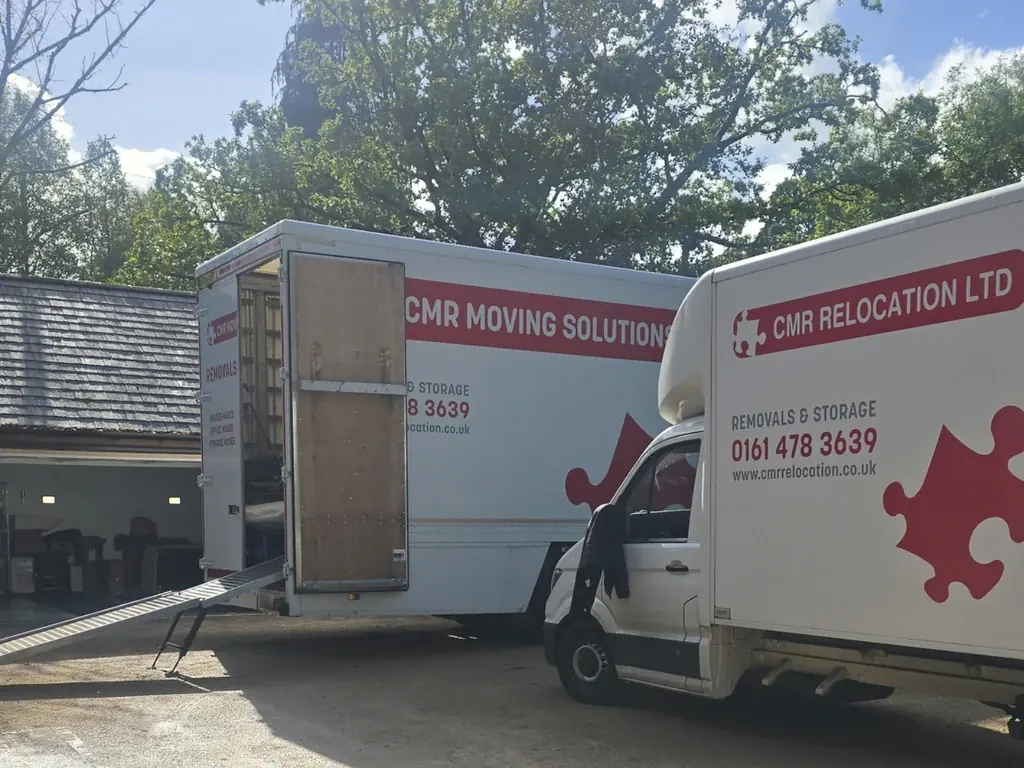 Two CMR Relocation vehicles reversed onto a gravel driveway