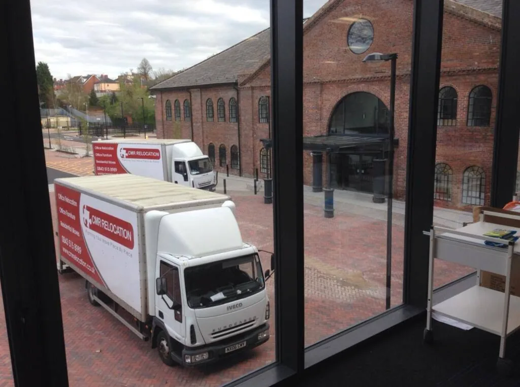 Two CMR Relocation lorries parked outside an office building for a commercial move