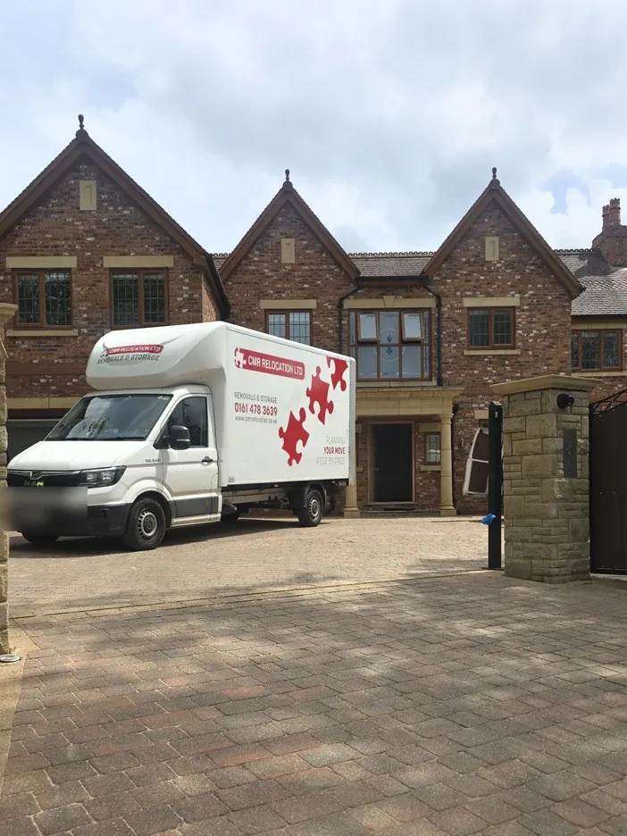 CMR Relocation van on the driveway of a stone-built house