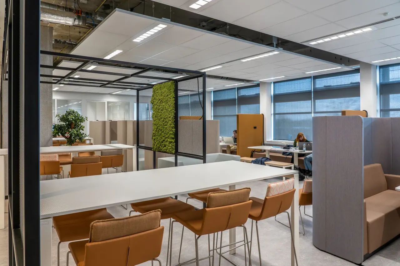 A few people working in a large office on a quiet hybrid working day