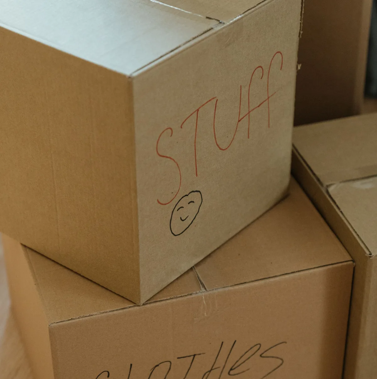 Packed moving boxes with hand-written room labels