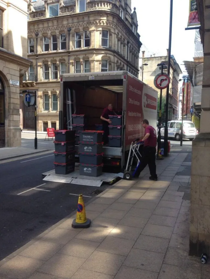 CMR Relocation crew loading office crates onto a tail lift in Manchester