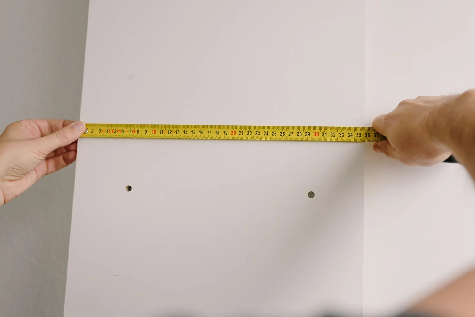 Tape measure against a wall, the first step in working out how much space your goods need