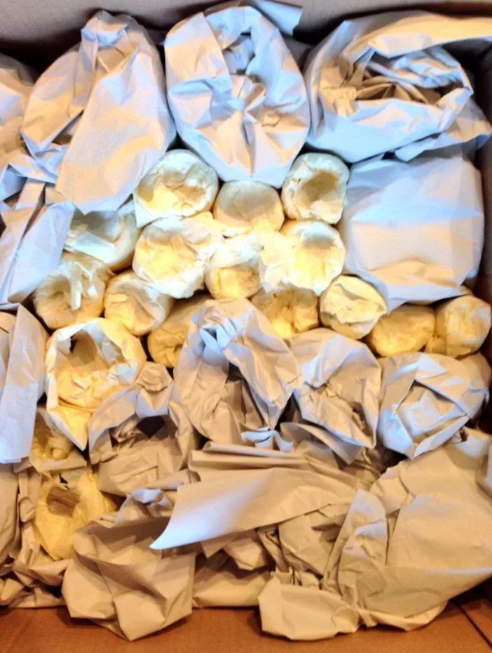 Crockery wrapped in packing paper and packed tightly for removals in Middleton