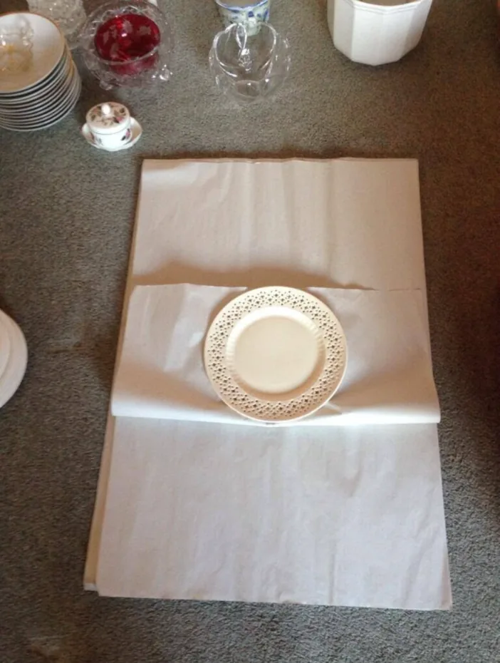 Plate wrapped in clean packing paper as part of a packing service quote
